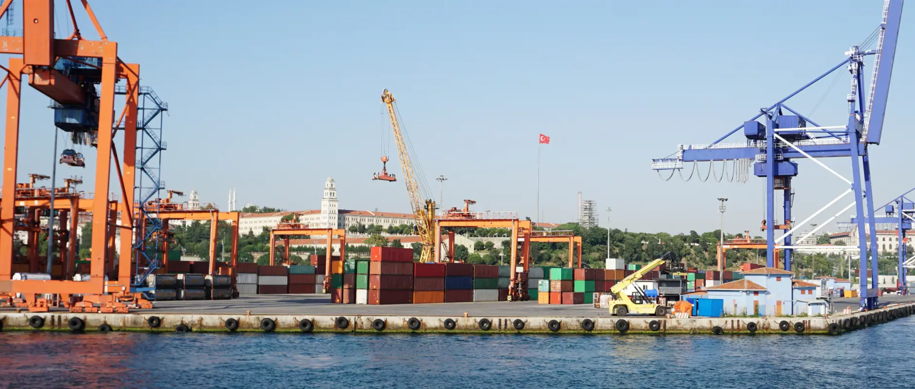 Container cranes and stacked shipping containers at a port, the trade Sourceforce buyers are sourcing for