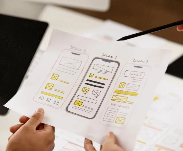 Designer sketching mobile app wireframes